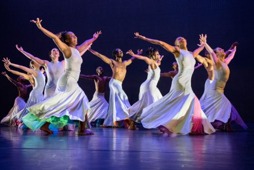 Deeply Rooted Dance Theater performing in white skirts and dresses