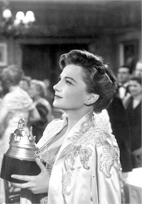 black and white image of a woman holding an award