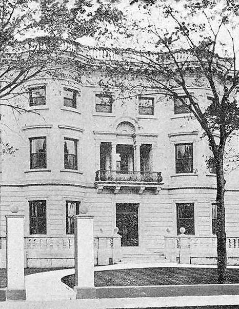 grainy black and white image of a large white mansion